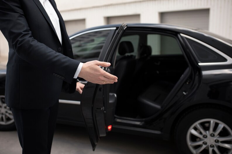 chauffeur open the limousine door to the costumer